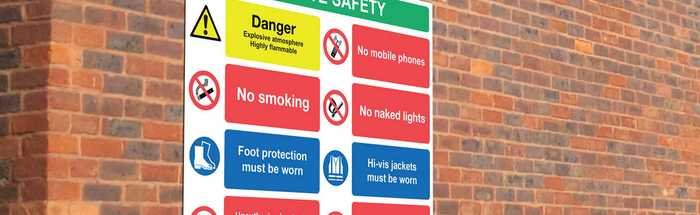 Safety signage board on a brick wall