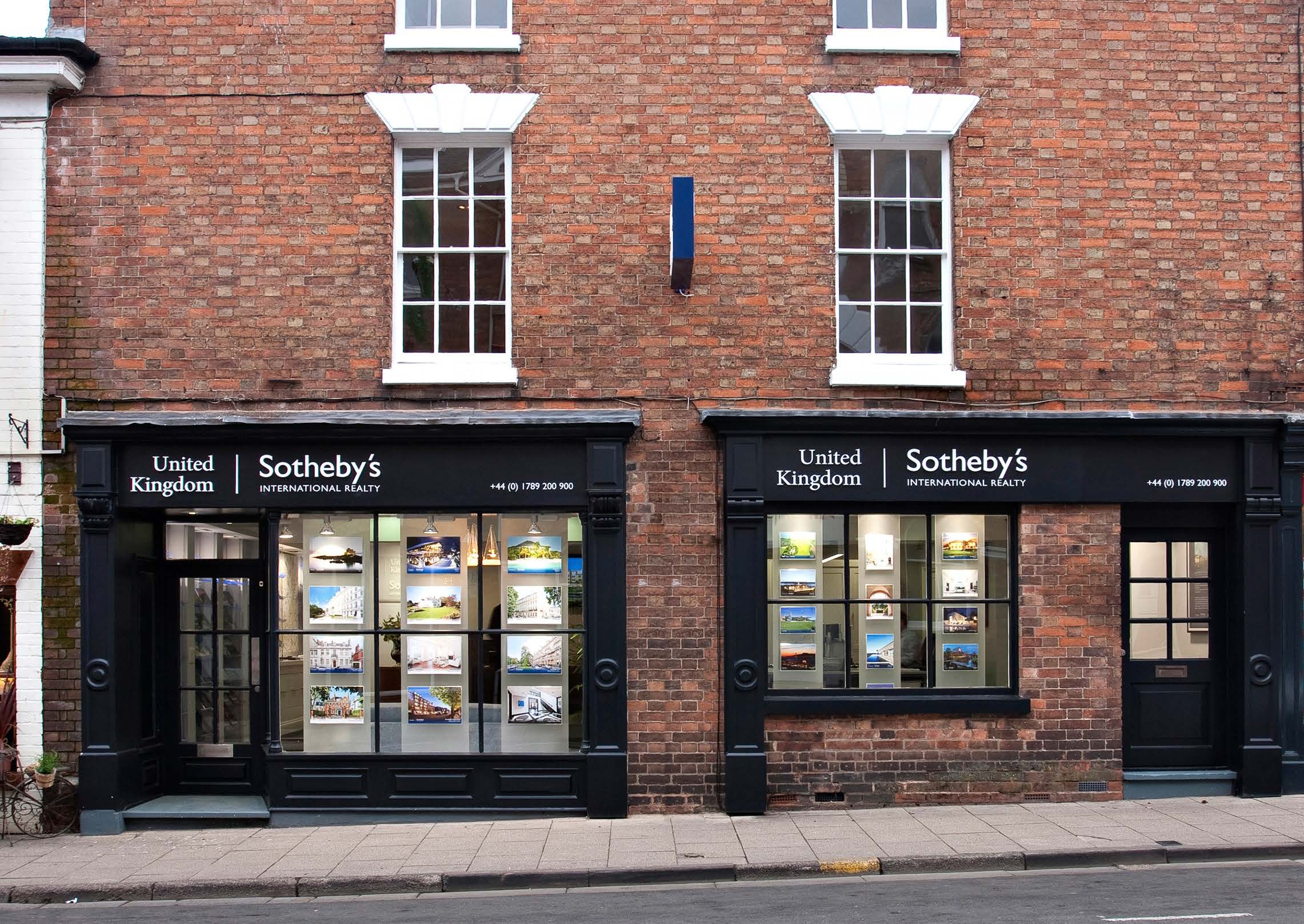Sotheby's International Realty double-fronted branch, black fascia and window displays