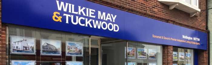 Wilkie May and Tuckwood fascia in blue with white lettering